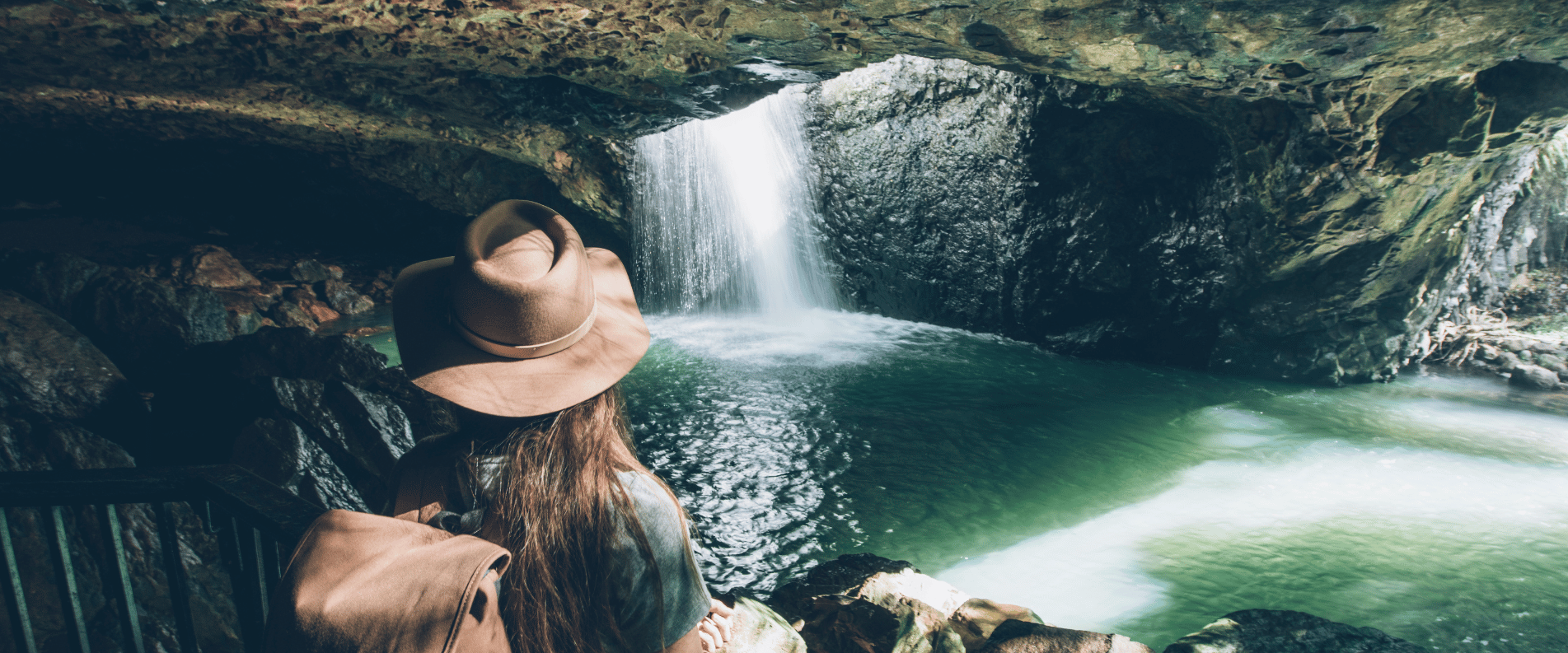 Woman under natural arch springbrook park